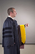 1. Candidates will be carrying hood over left arm.